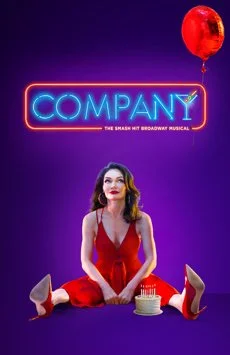 A woman in a red dress sitting on the floor with a birthday cake in front of her, holding a balloon, against a purple background with neon 'COMPANY' sign.