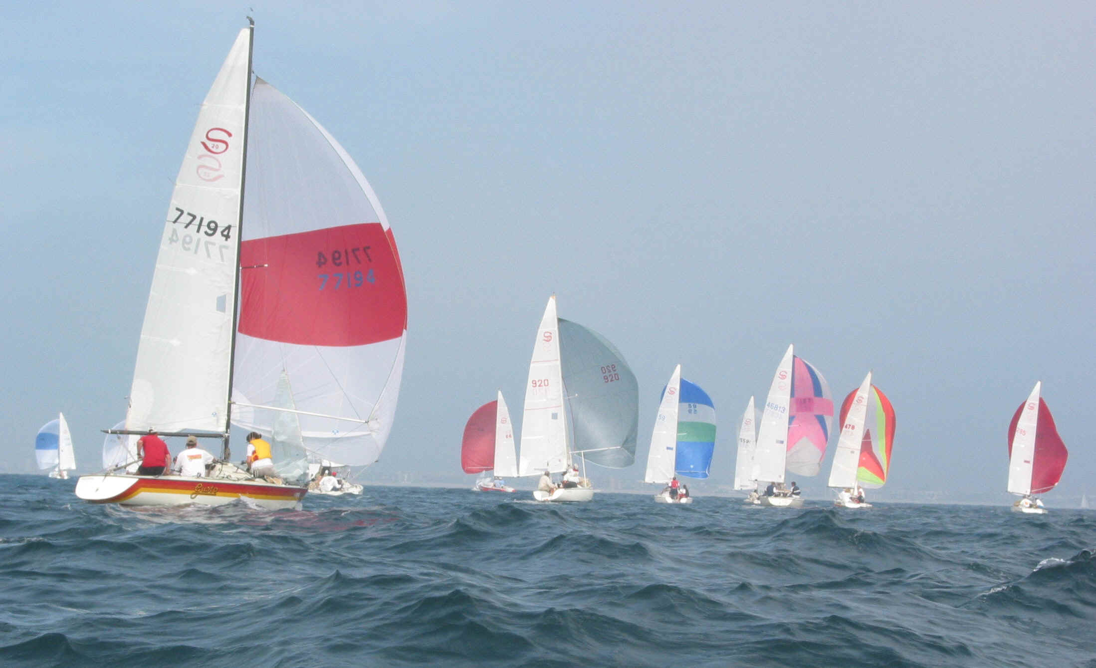 The spinnaker on the left has the pole a little too low - notice how the curl on the luff of the sail is a little high
