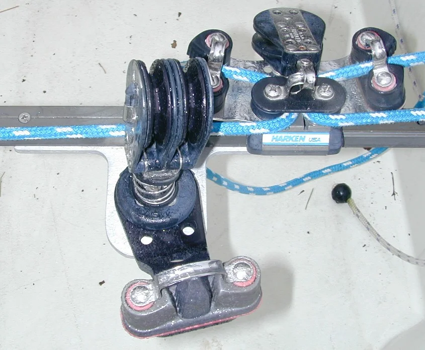 Top ViewMainsheet Bracket 2 = view from top. Bracket sized to provide clearance between track and swivel for car and control line to pass. Traveler car is high-load Harken with cleats mounted on car. Some people use a windward sheeting car.