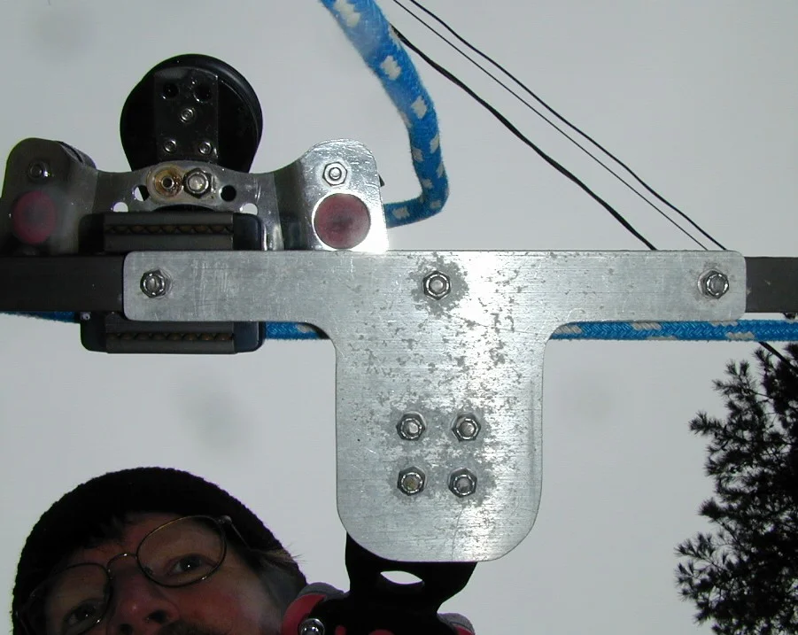 View from Underneath the Traveller Mainsheet Bracket 3 = view from bottom. Aluminum bracket (1/4" plate) bolted to traveler using SS bolts and nylon lock nuts. Ends of bolts are cut off to prevent damage.