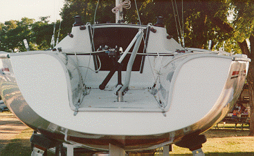 This next shot is a close-up of the transom showing the detail of the new tiller and how it goes through the floor. Tom has also put a barney post on his boat so the main sheet will always be in the same place. Notice the new backstay and how it is split and attaches to the transom.