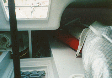 This interior shot is taken looking aft into the quarter berth. Notice how the aft quarter berth is much bigger with the new side tanks on the deck. There is a lot more headroom now. You may also see the lead in the keel pan. That was there because the keel was too light when the boat was put together. The crew was working on the boat to add weight right up until the regatta started. That's why the boat was christened "Still Wet".
