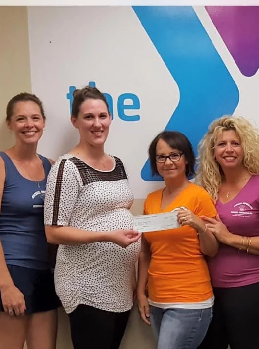 A check being presented to the Genesee County YMCA Challenger Program for $1,000. L to R: Board Member Ellen DellaPenna, YMCA Challenger & Aquatics Coordinator Megan Boring, Board Members Donna Kabel and Diane Hale