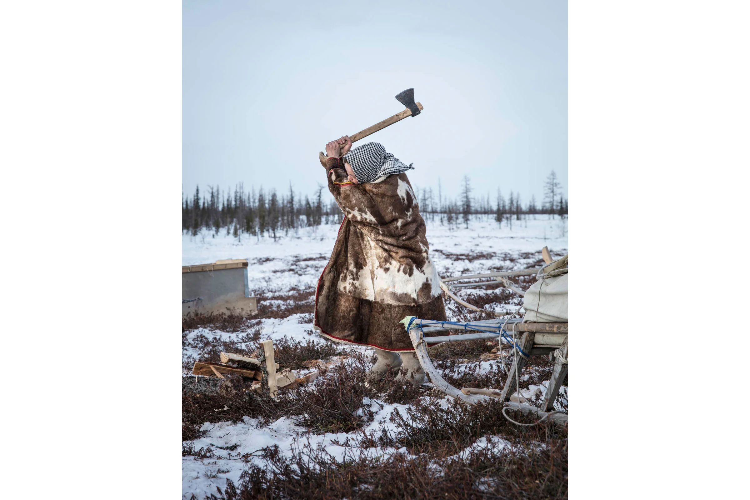 Female Herder chopping wood