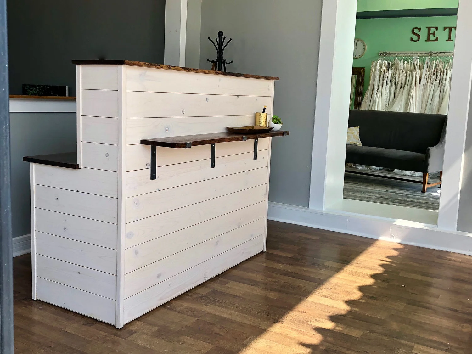 custom urban set bride reception desk with live edge walnut and ship lap. cash wrap