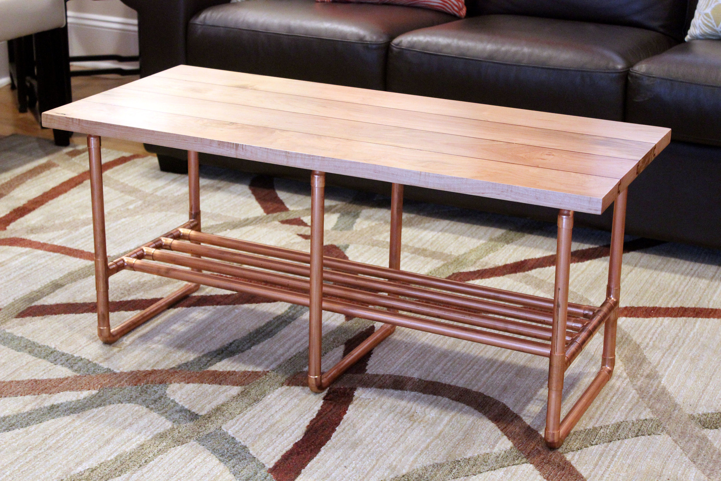 custom maple coffee table with copper inlay and copper pipe legs