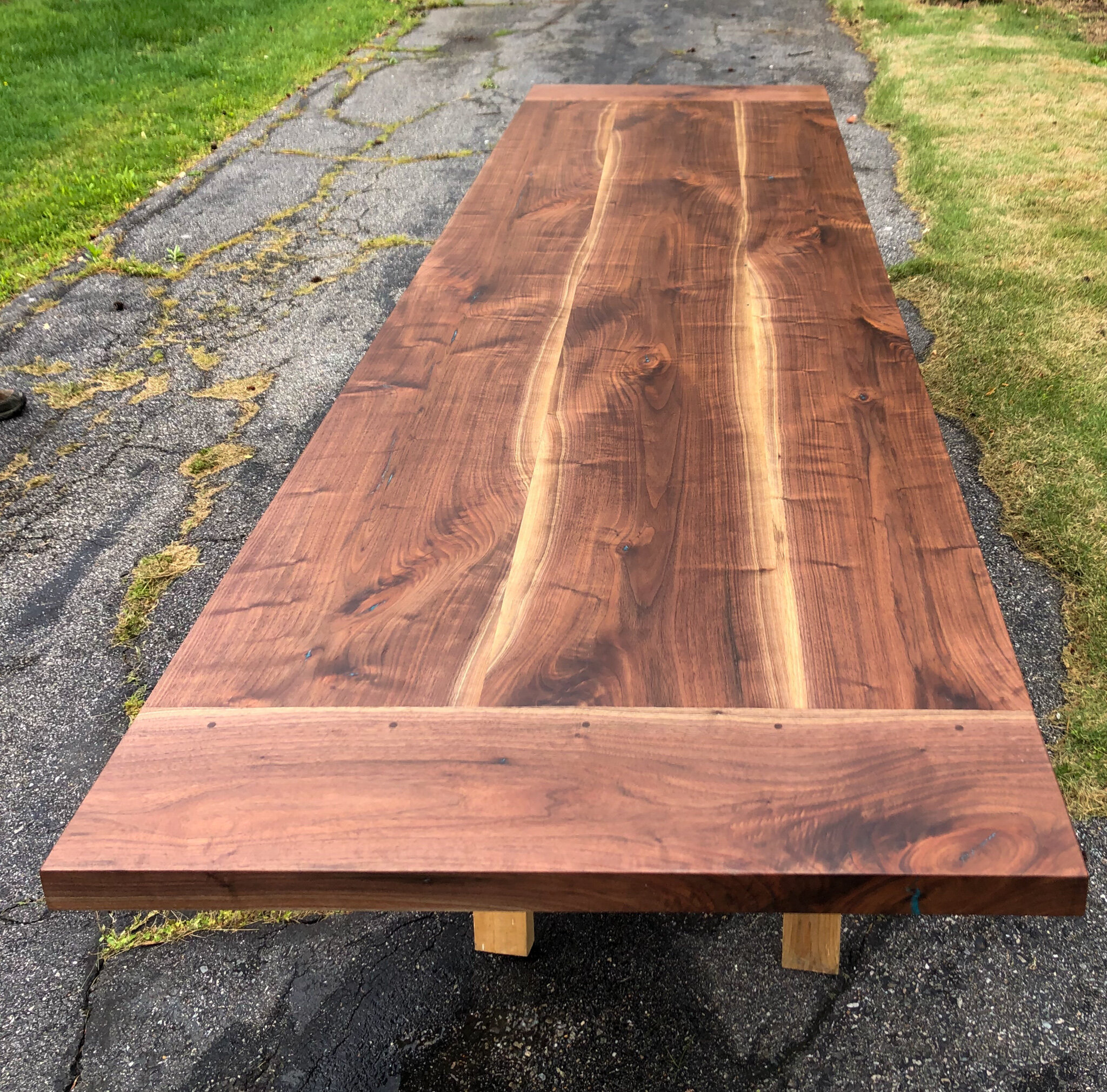 11 foot walnut trestle table with breadboard end and blue epoxy details. Sallie Plumley Studio richmond Virginia 