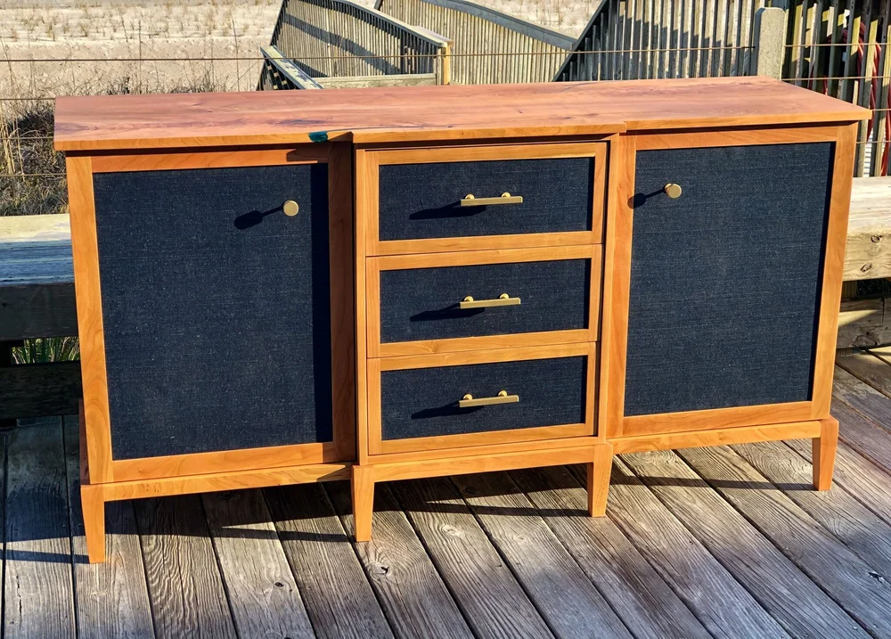 Cherry Sideboard with Navy Grasscloth Wallpaper and Brass Hardware