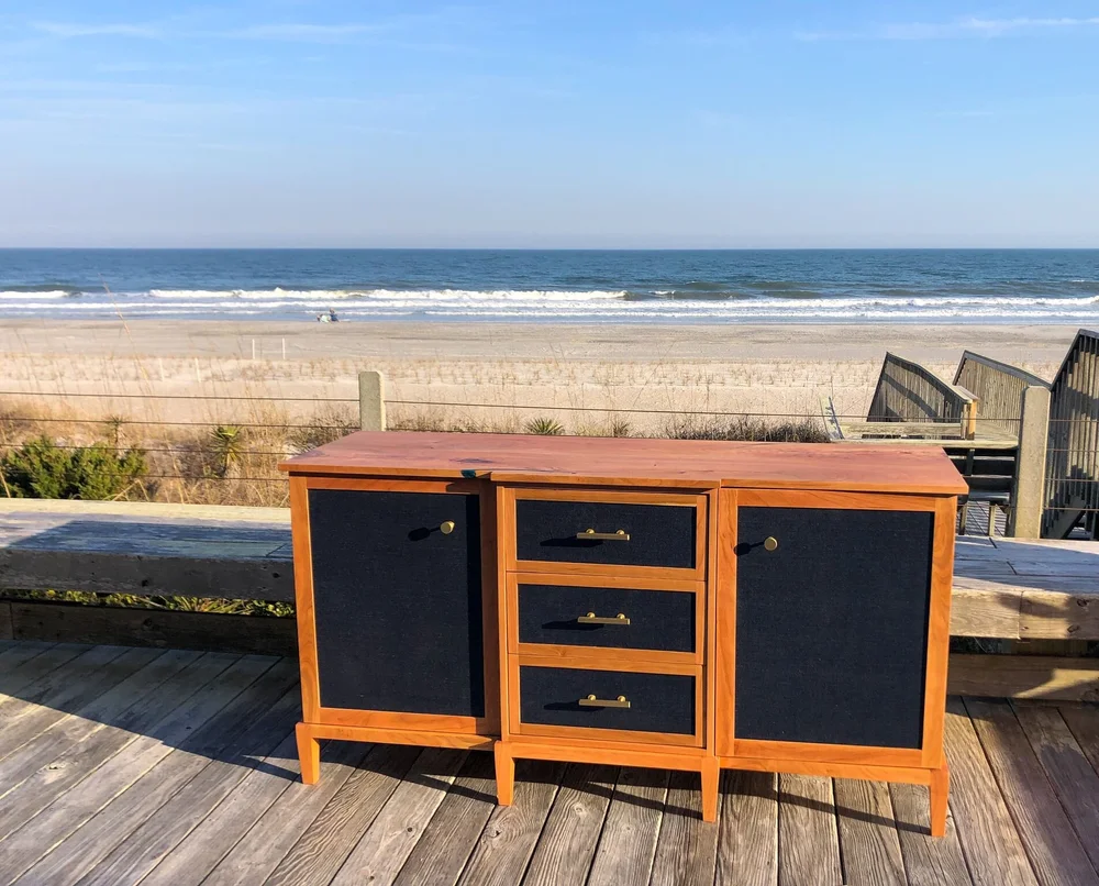 Cherry Sideboard with Navy Grasscloth Wallpaper and Brass Hardware