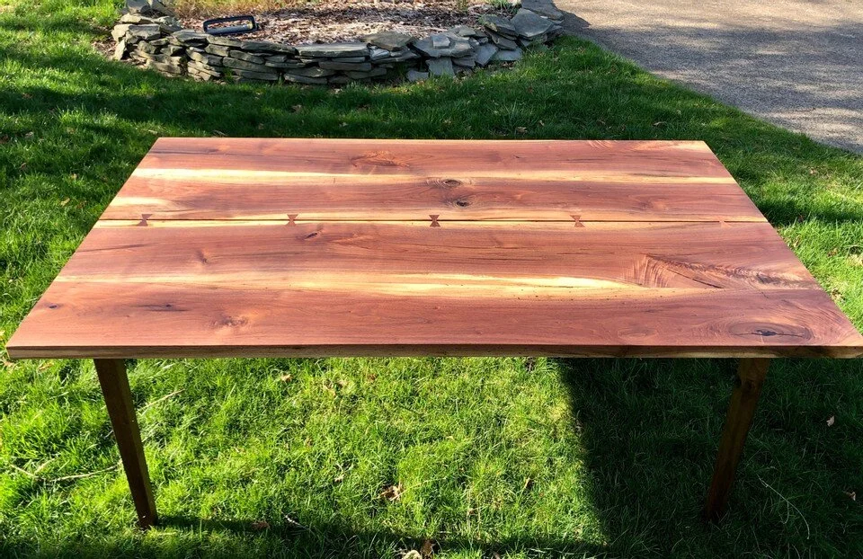 sleek walnut table with crack and bow ties 