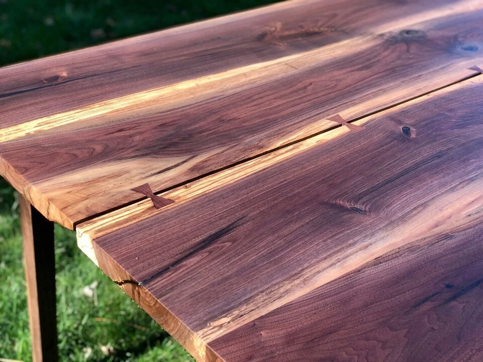 sleek walnut table with cracks and bow ties 