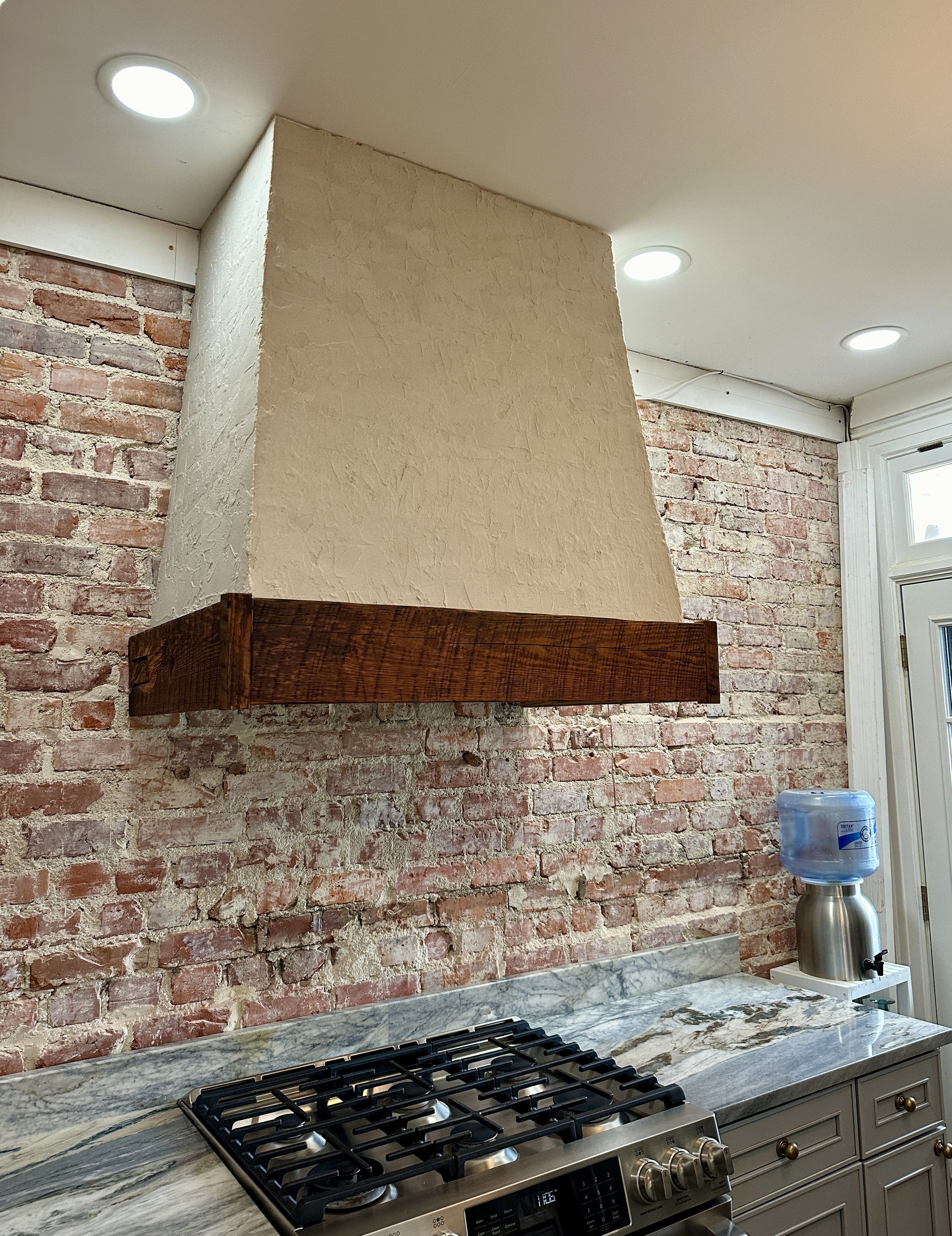 Wooden Beam and Stucco Range Hood Cover