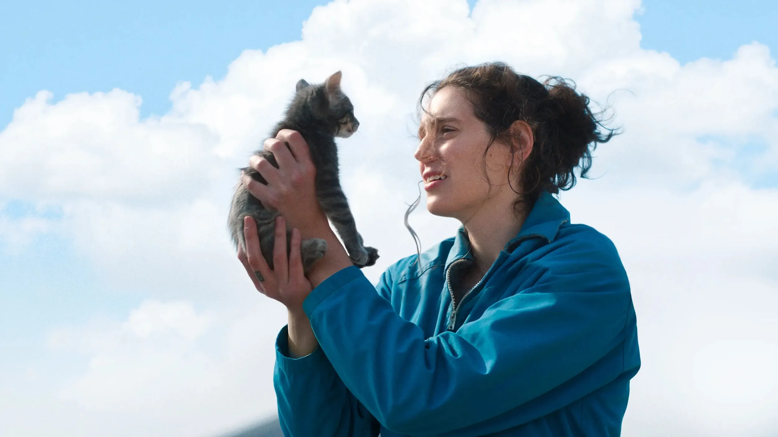 Eva Victor from Sorry, Baby holding a cat.