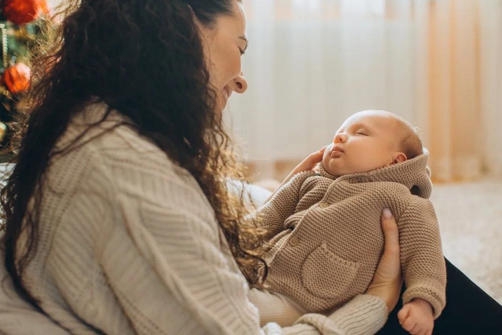 mother holding and looking at her baby