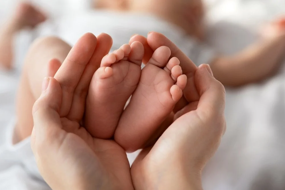 mom holding baby's feet