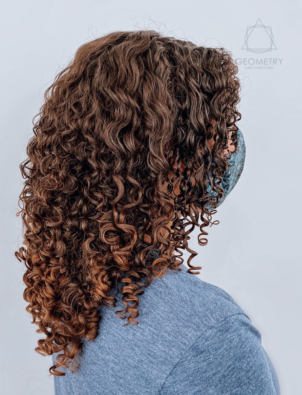 Chestnut brown curly hair color and cut