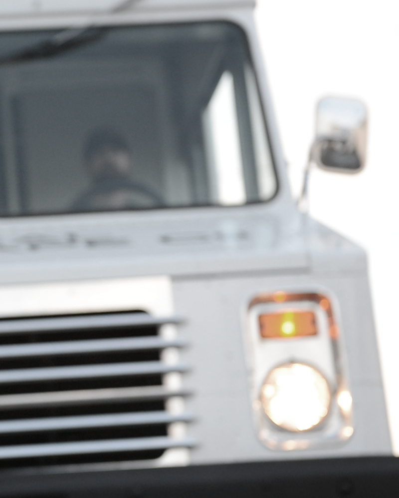 An ugly and stupid guard driving the escape truck prison transport vehicle