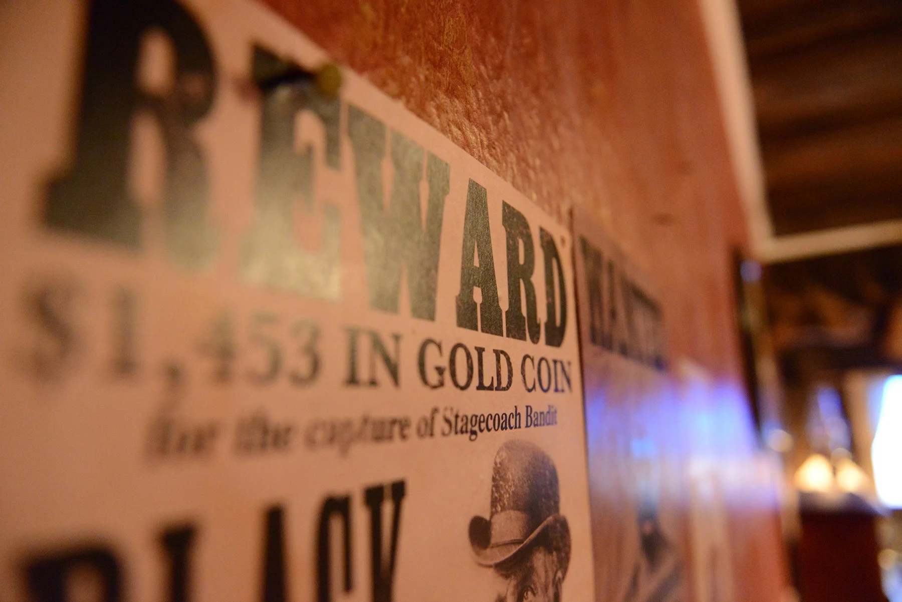 Multiple Wanted posters hang on the walls of the Saloon offering reward for capture or kill