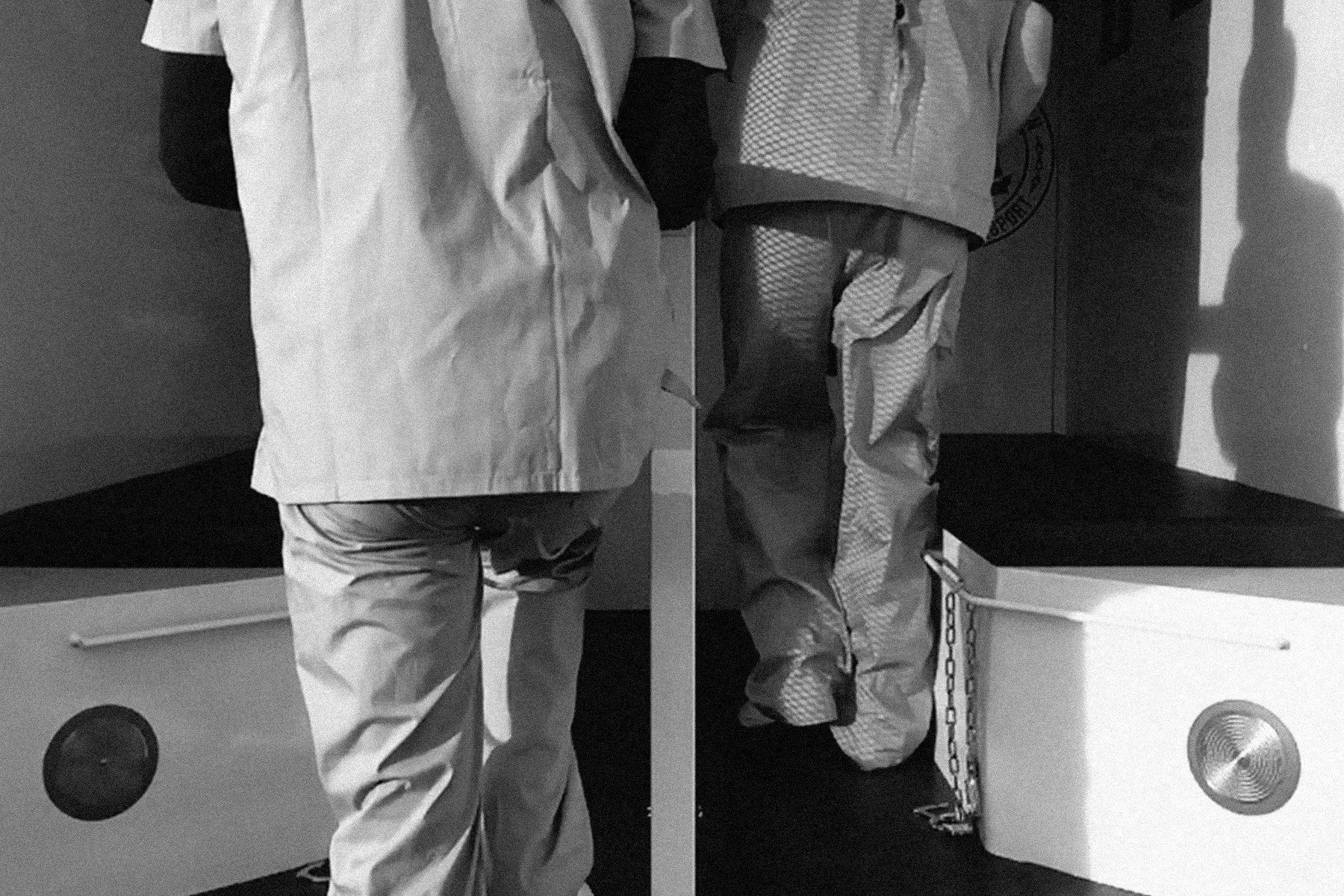 Inmates load into the back of the prison transport vehicle