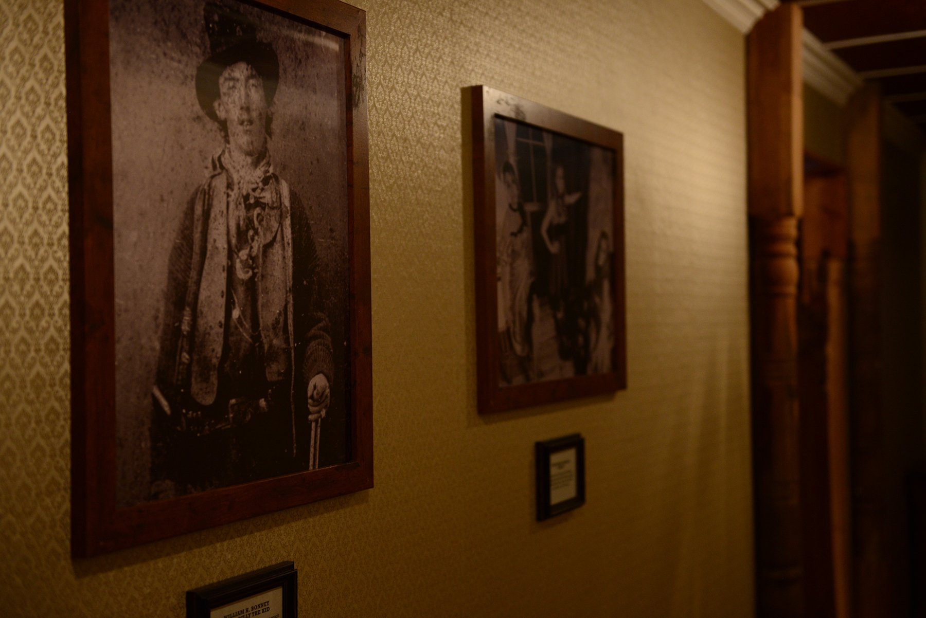 A photo of Billy the Kid hangs in the entry hall of the Saloon which has been converted to a museum