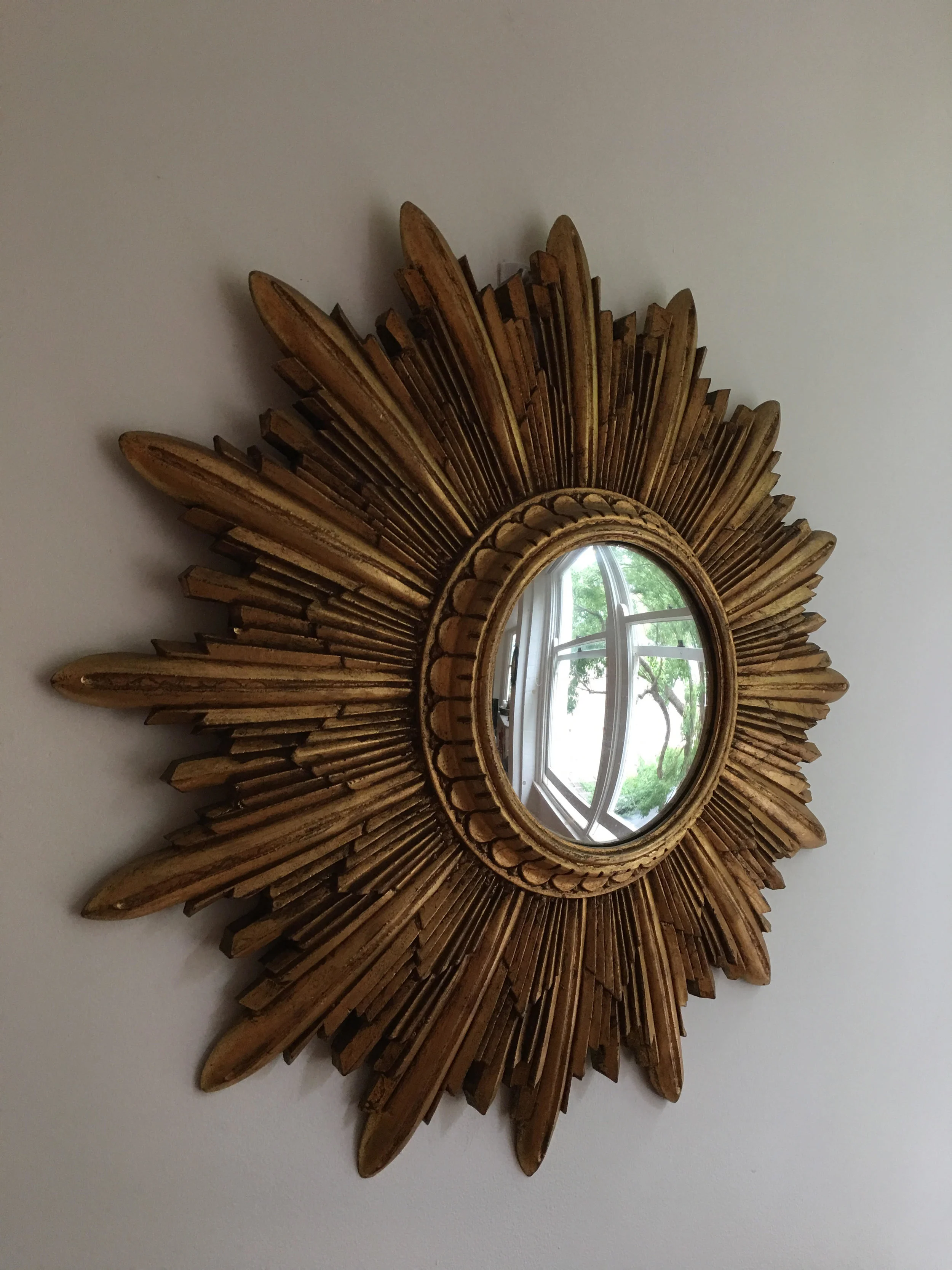 Sunburst mirror with a gilded frame supporting a convex mercury glass circa 1900