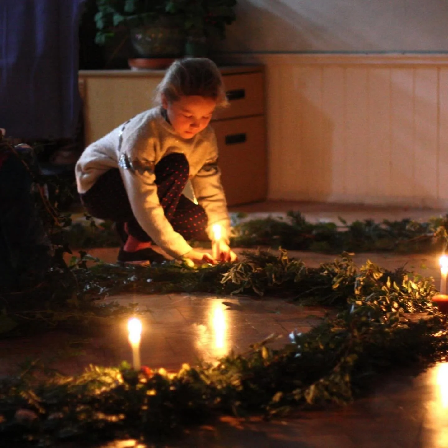 Advent Spiral 🕯️🍎🌲🌟

My daughter at her annual advent spiral this week. Each child walks around this beautiful spiral, lighting their own candle (mounted in a rosy red apple) from the big candle in the centre. They then place it in the evergreen 