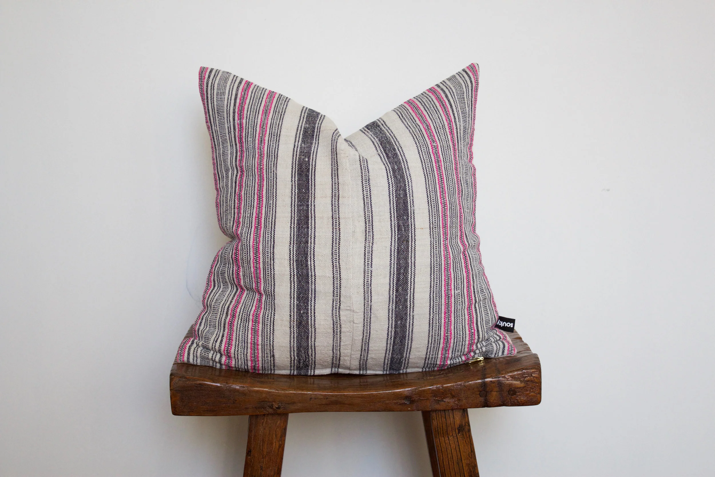 Finley - No. 142 275 RMB Pillow cover is made from handwoven hemp fabric sourced from Northern Thailand Size: Roughly 40x40 cm Pillow back is made from a neutral cotton/linen blend Zipper on bottom of pillow Down insert included Hand wash in cold water