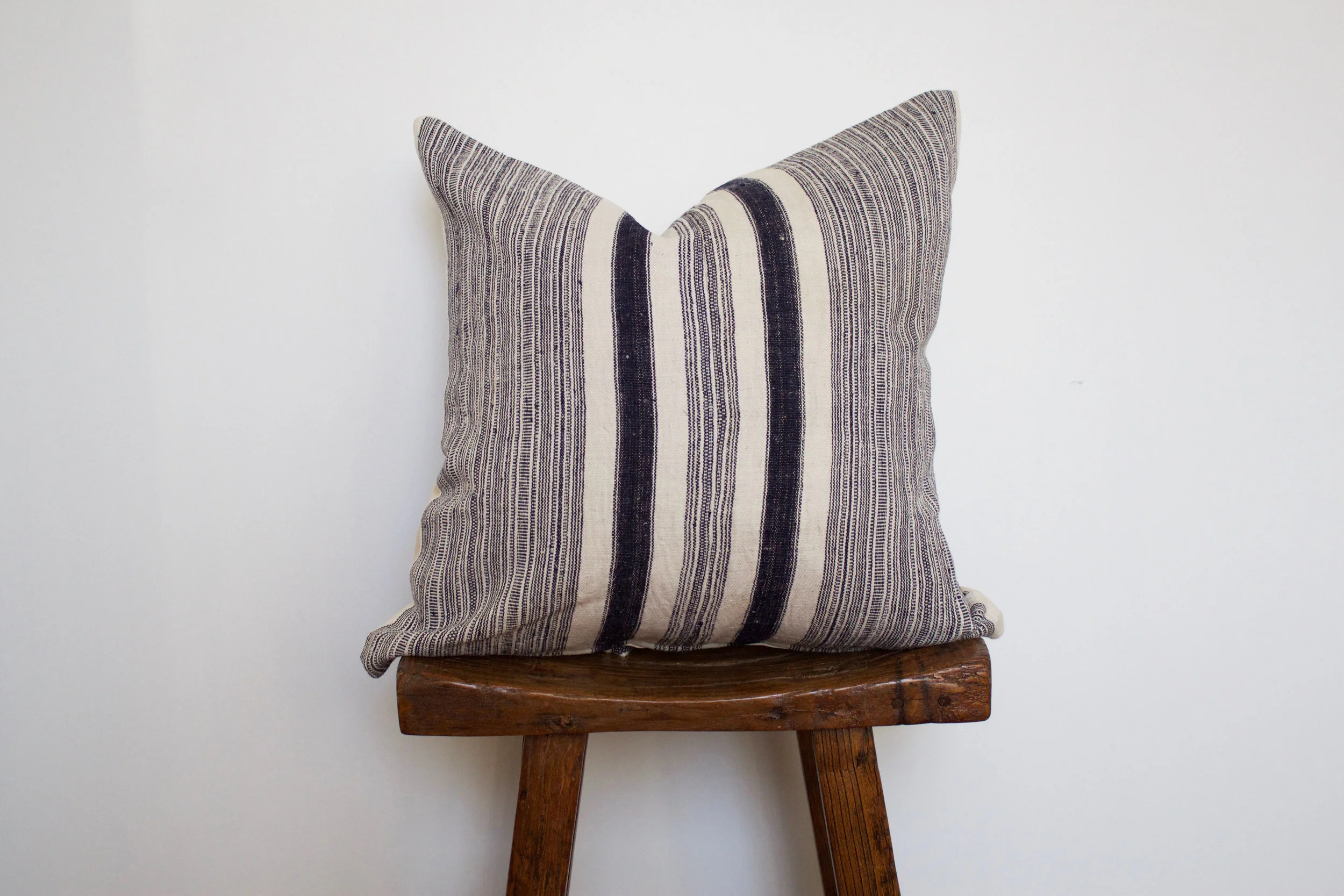 Tristen - No. 133 350 RMB Pillow cover is made from handwoven hemp fabric sourced from Northern Thailand Size: Roughly 50x50 cm Pillow back is made from a neutral cotton/linen blend Zipper on bottom of pillow Down insert included Hand wash in cold water