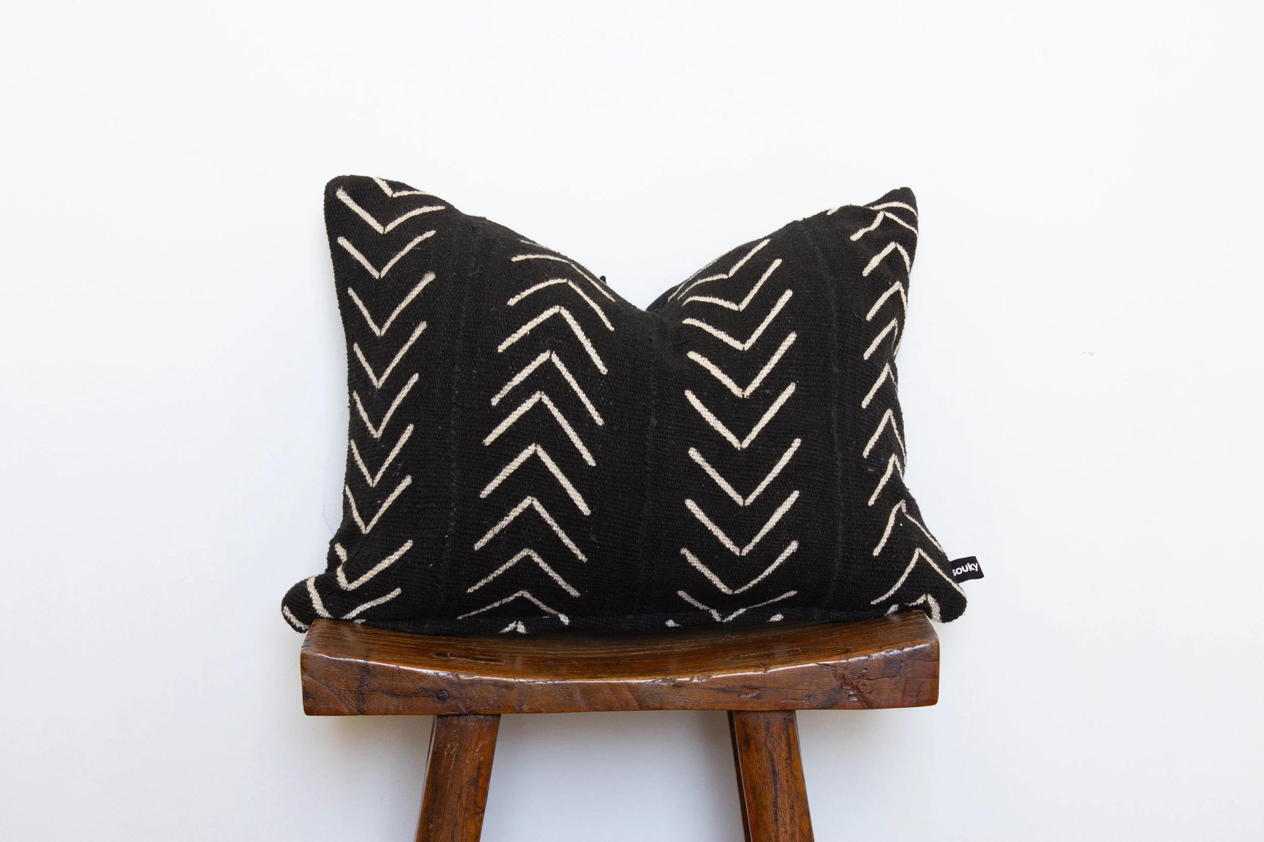 Brenna- 1 available 320 RMB Pillow cover is made from black African mud-cloth sourced from west Africa Size: Roughly 49x35 cm Pillow back is made from a neutral cotton/linen blend Zipper on bottom of pillow Down insert included Hand wash or spot clean recommended