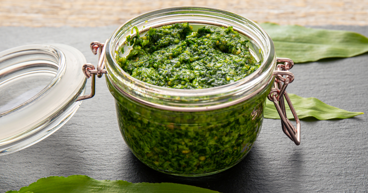Kilner jar of wild garlic pesto on a black slate board
