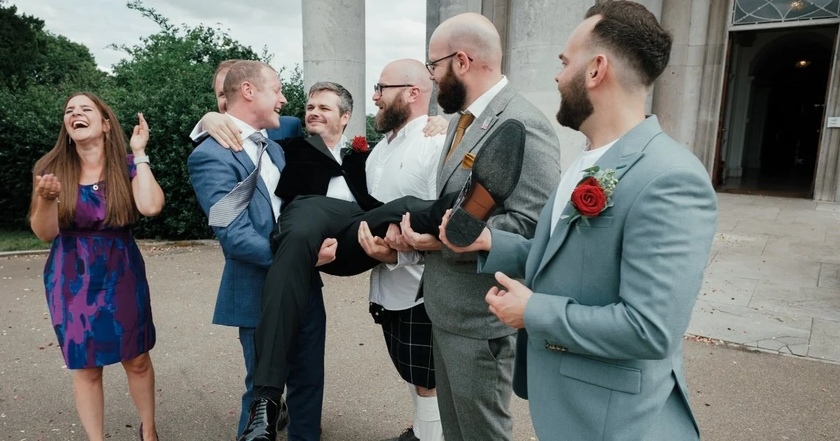 Wedding guests laughing together during an evening reception at Beckenham Place Mansion catered by Salters Events