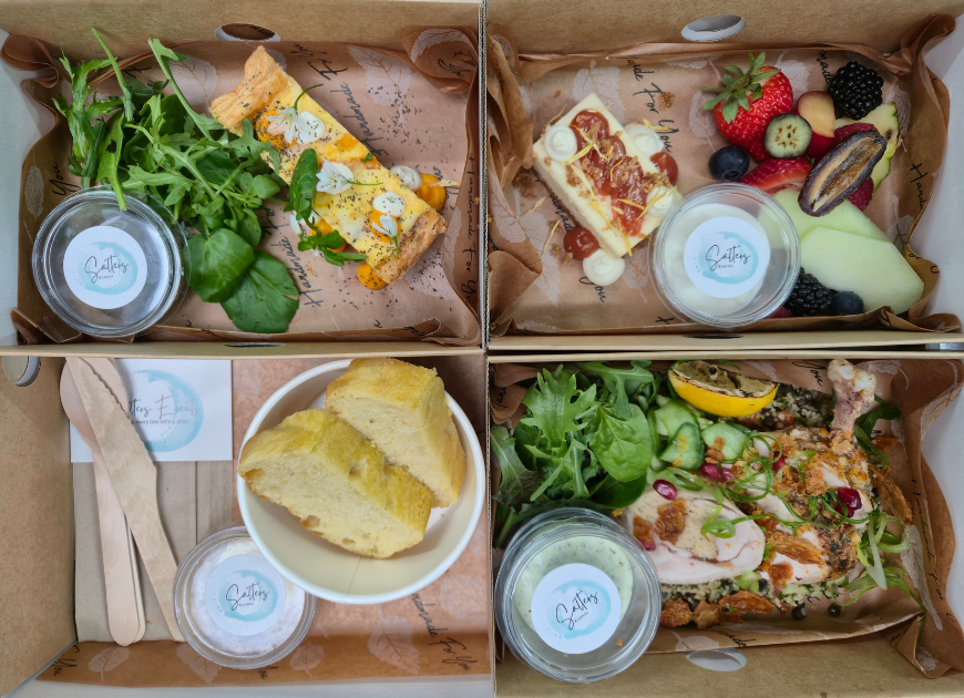 Salters Events Boardroom Bento Box presented in eco - disposable platter box. Featuring Moroccan spiced chicken, squash and goats cheese tart, rhubarb cheesecake, fresh baked bread and fruit platter