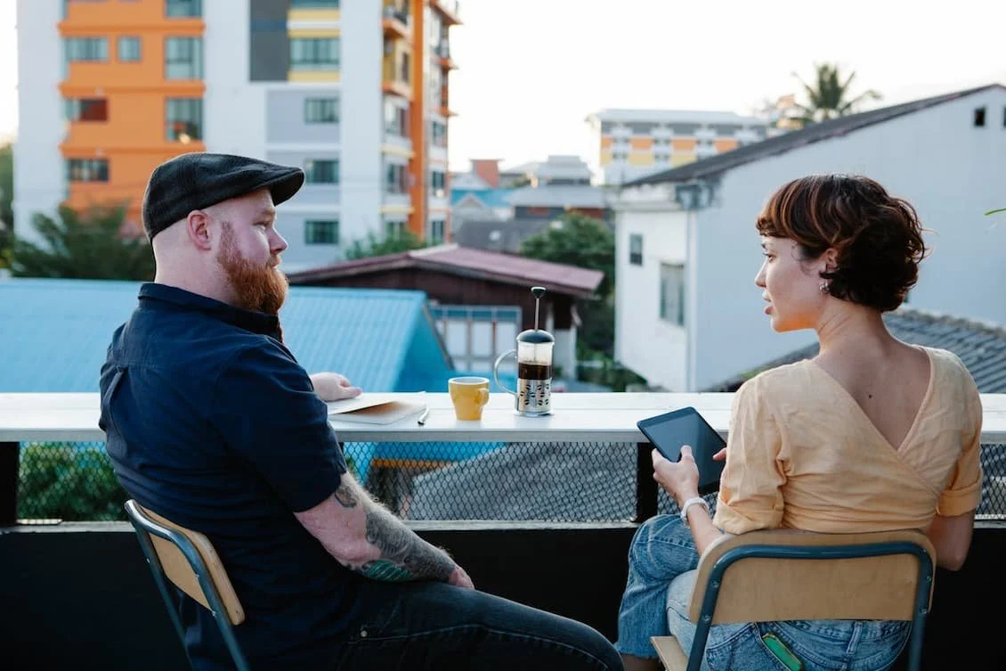 man-and-woman-chatting-and-resting-on-terrace