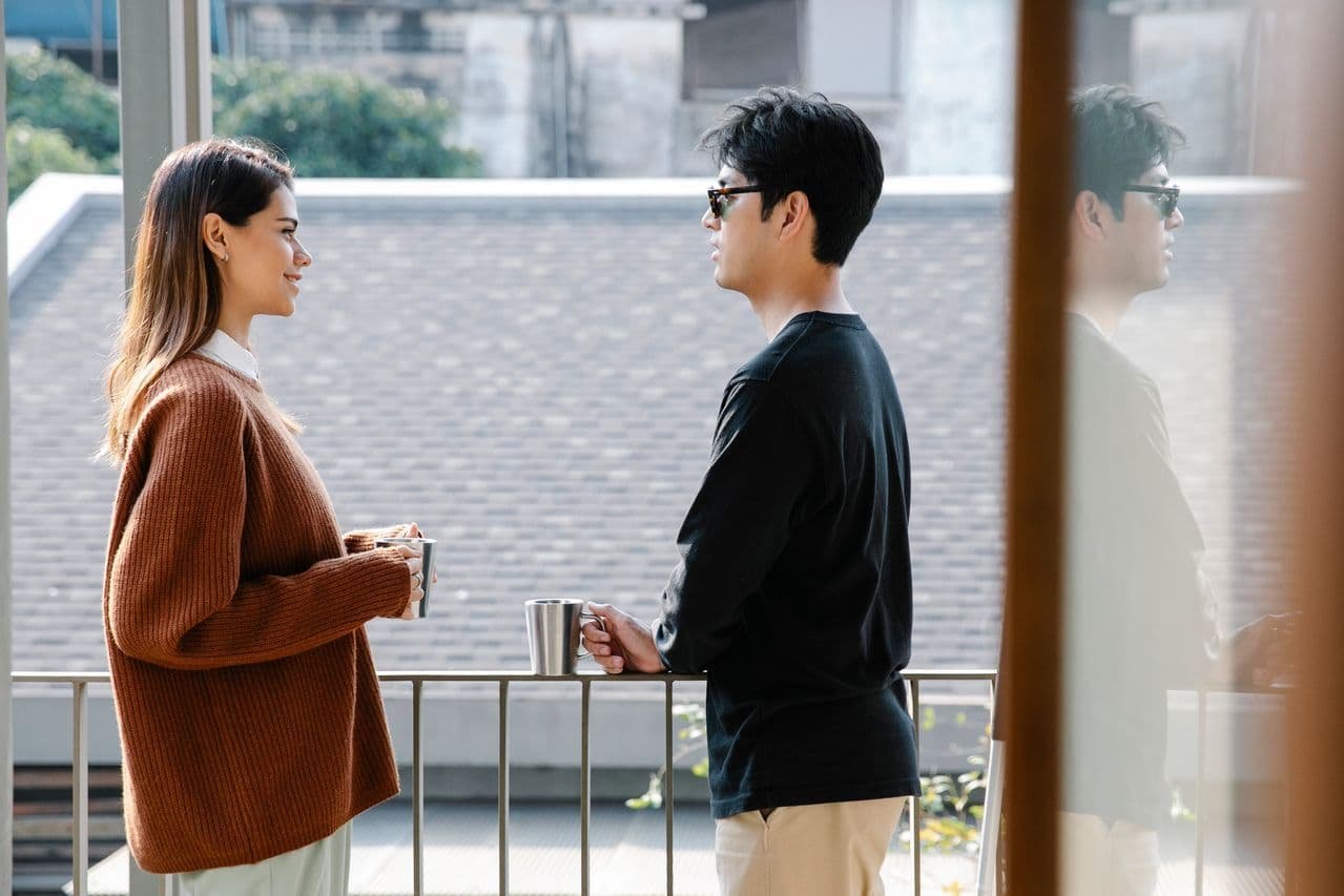 man-and-woman-chilling-in-the-balcony-
