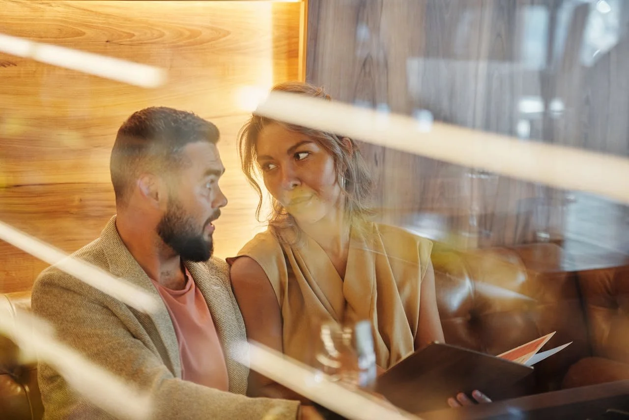 man-sitting-beside-woman-holding-a-menu-card