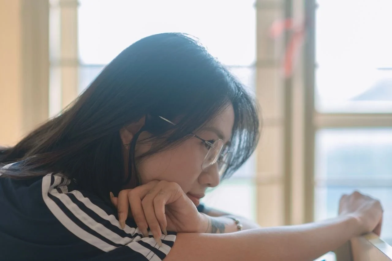 pensive-young-woman-relaxing-indoors
