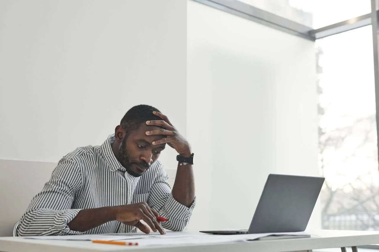 a-man-working-with-his-hand-on-head
