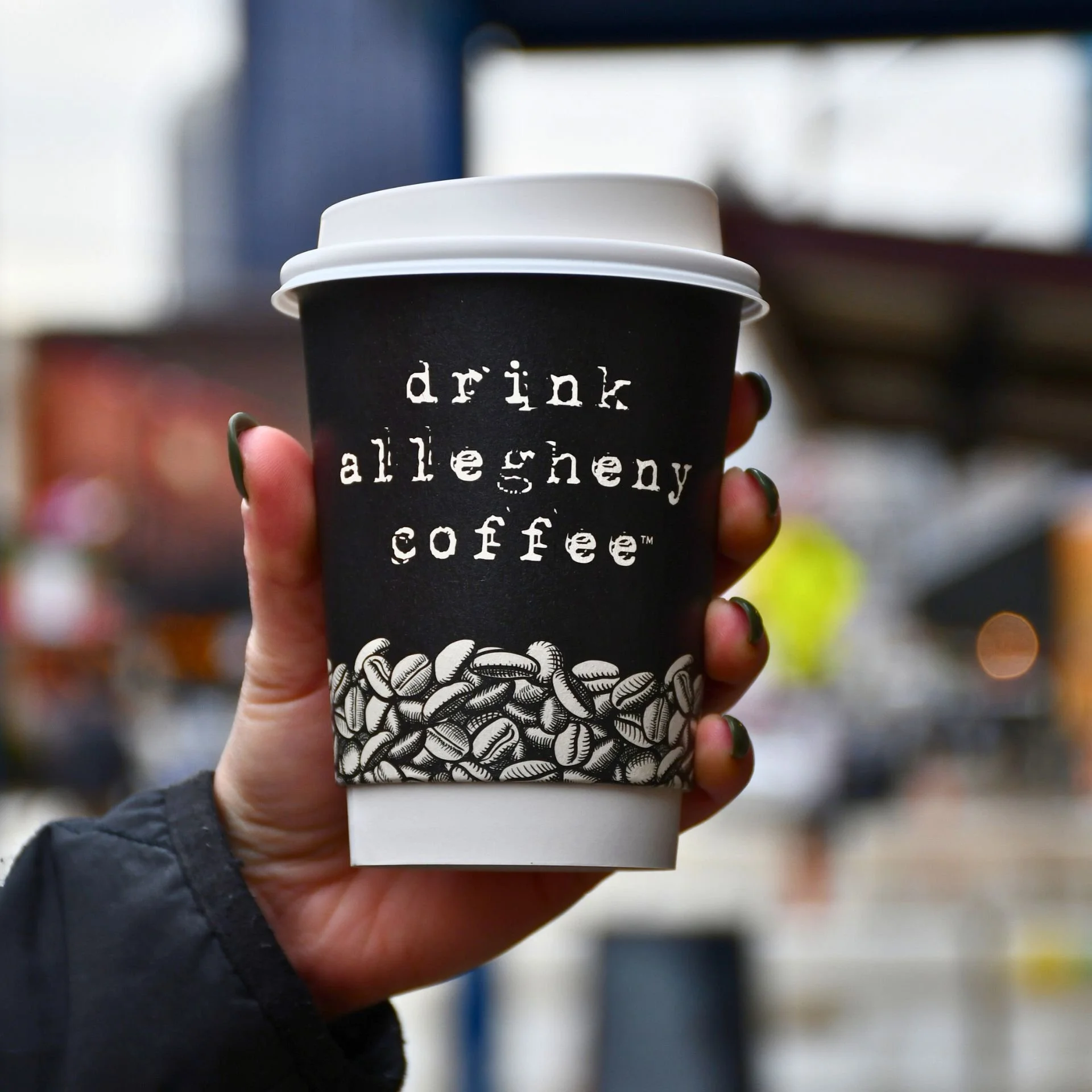  small, hot chai in a paper coffee cup that says: ‘drink allegheny coffee’ 