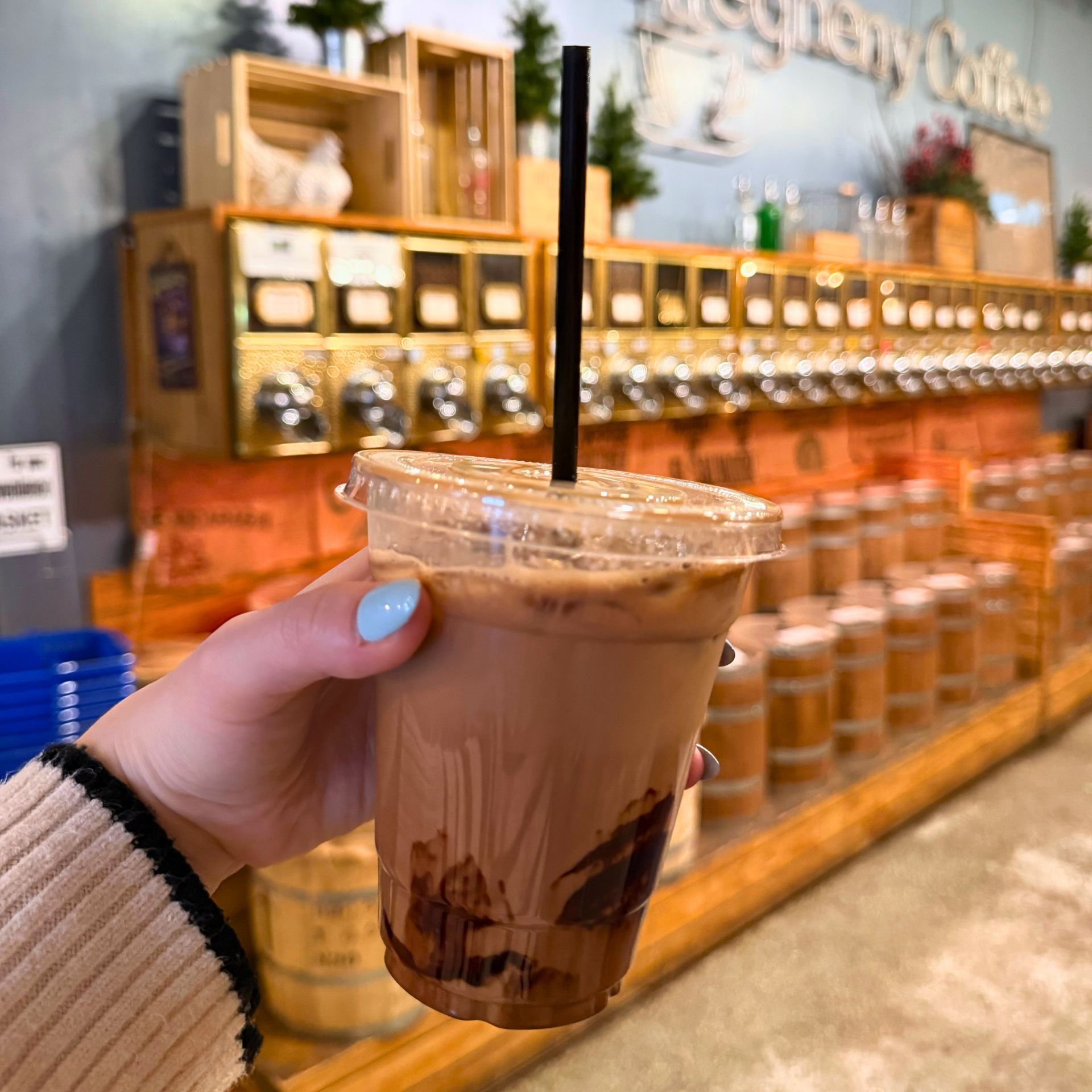  holding an iced mocha inside Allegheny Coffee 