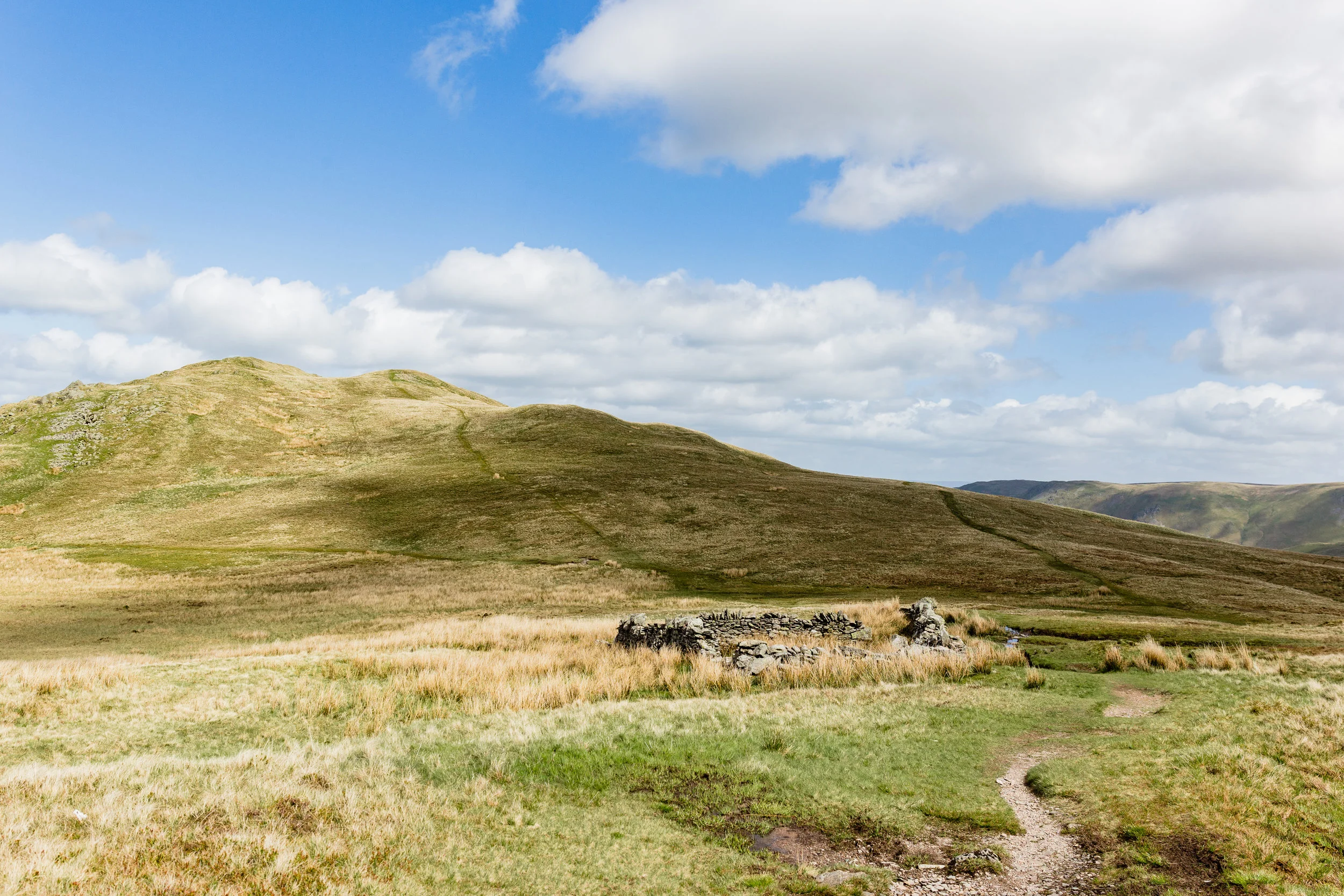 Looking back at the sheep-pen. The path running off to the left is the one you have just walked up.