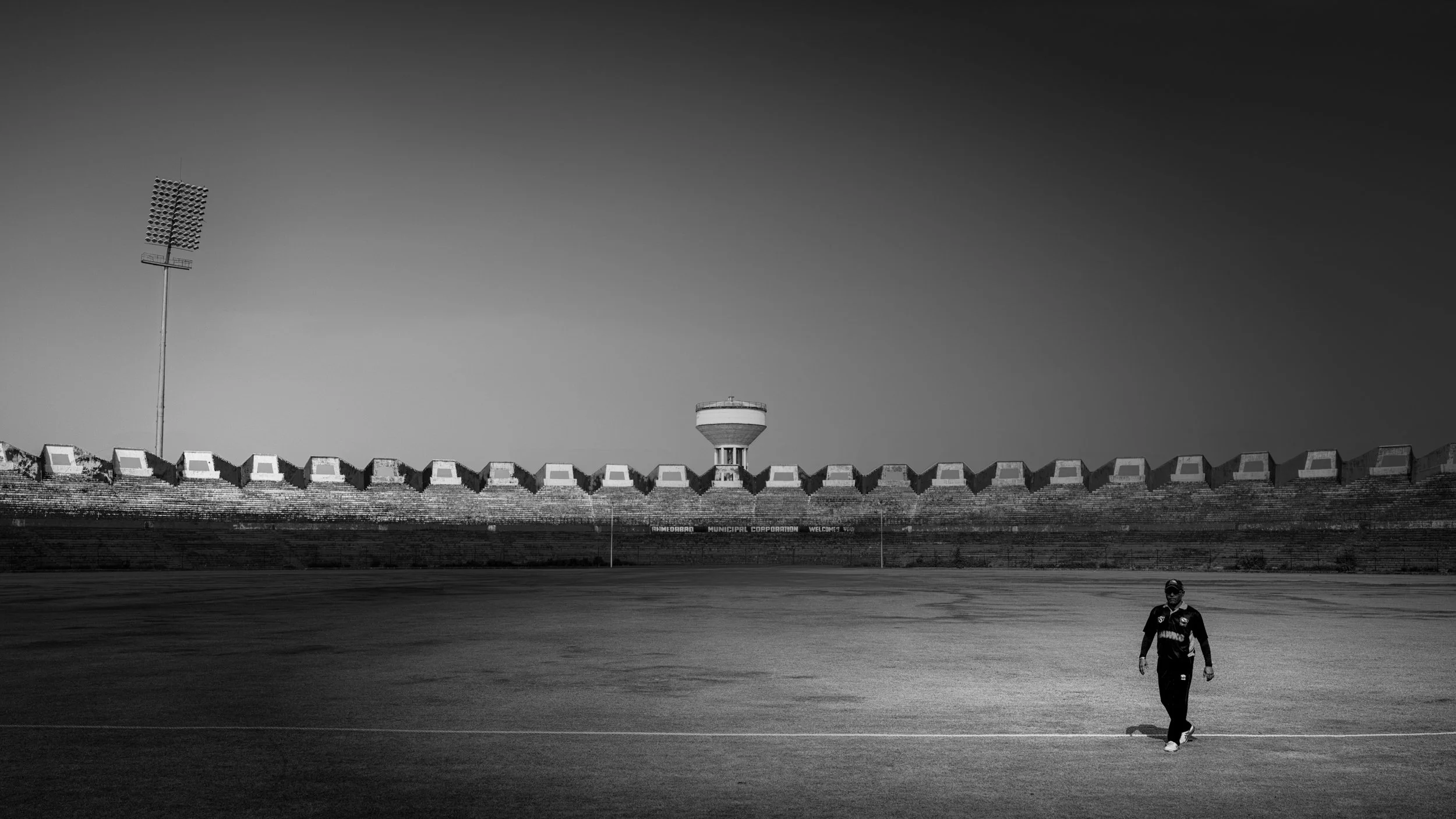 Wide view of Sardar Vallabhbhai Patel Stadium in Ahmedabad with a small group practicing on the field inside the large stadium.