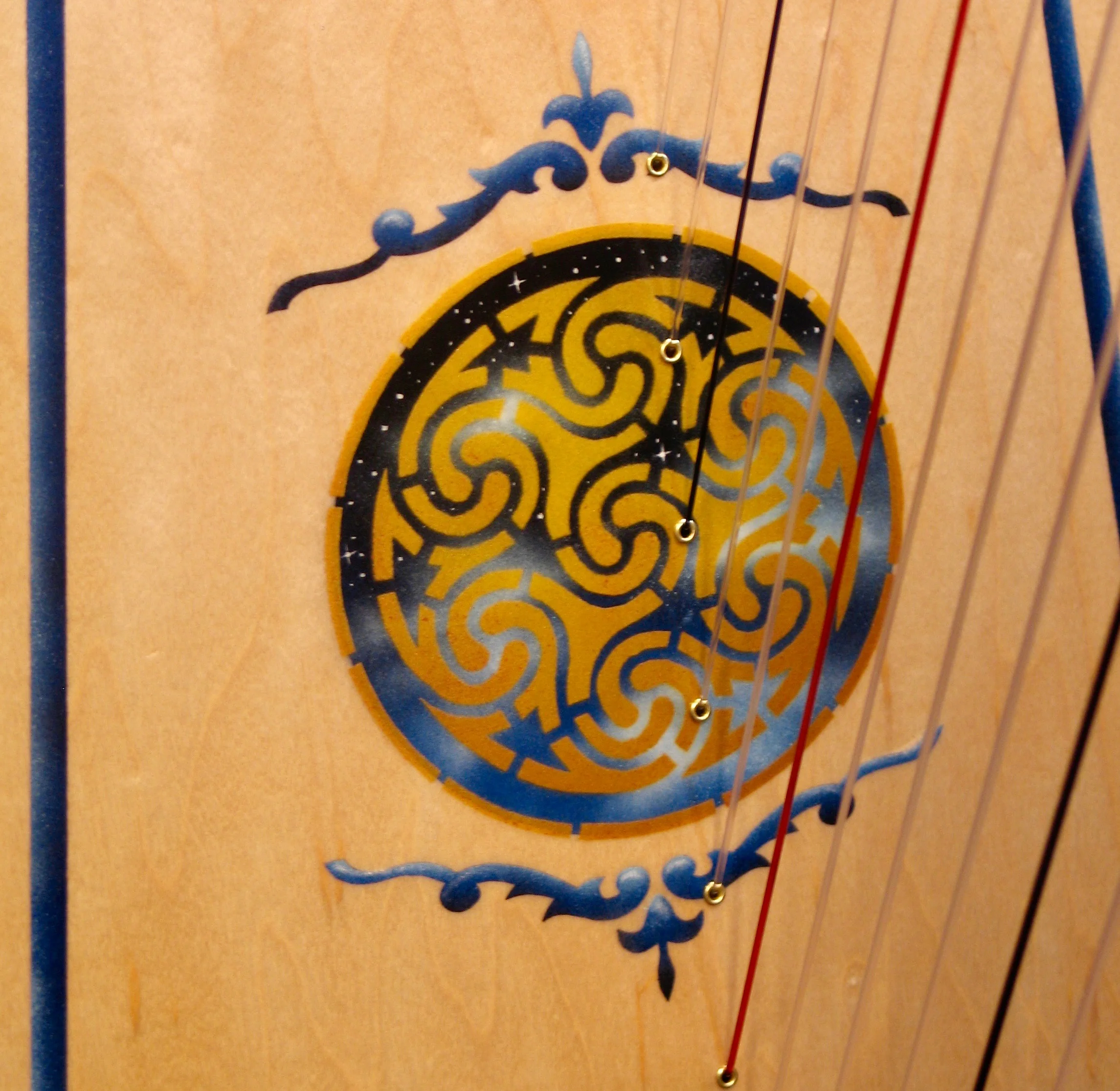From our standard ornamentation catalog this is Starry, Starry Night in gold with a Celtic Border framing the soundboard.