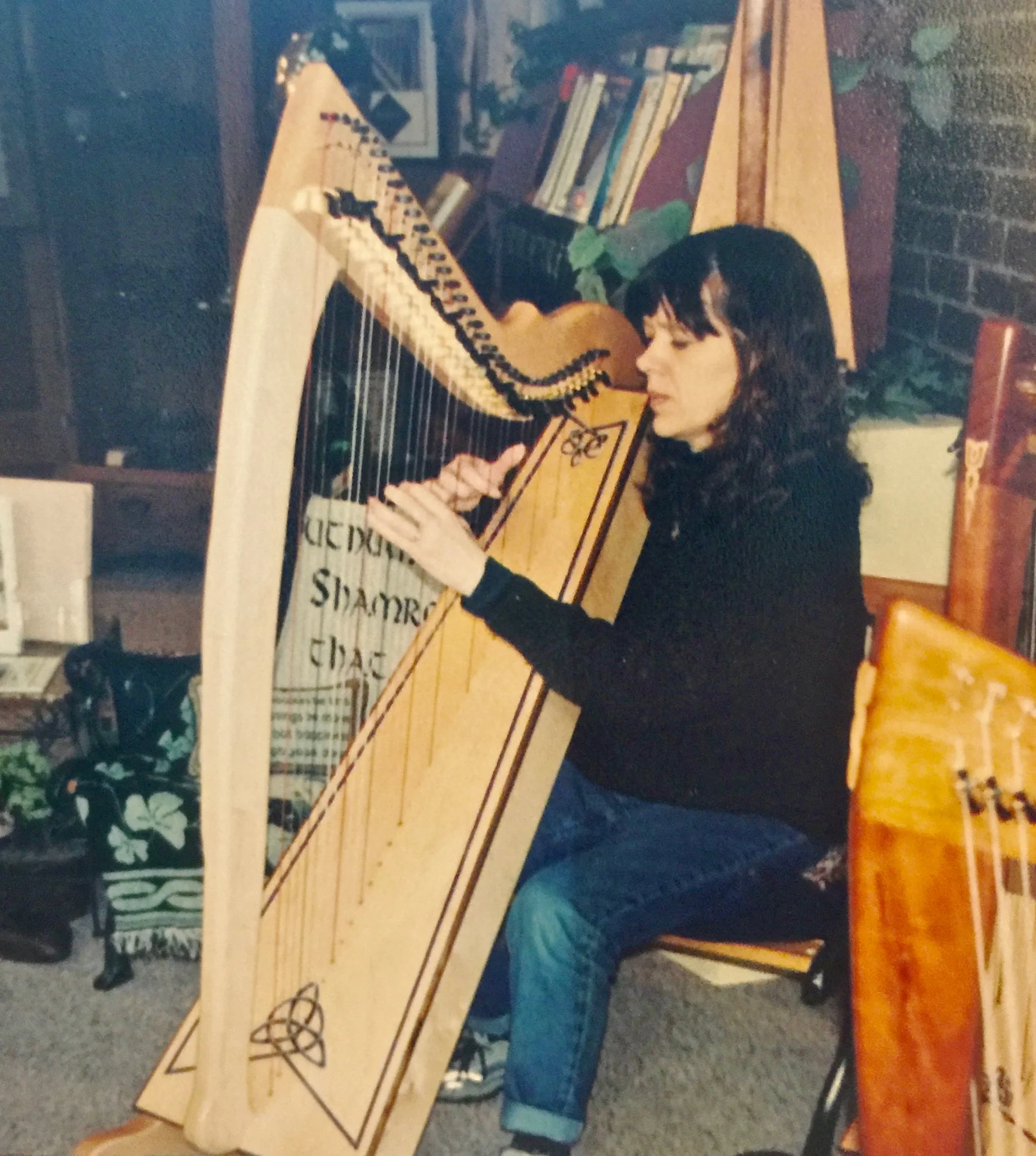 Kathleen Dlabick trying out a Corlieu Falls Harp in our showroom.