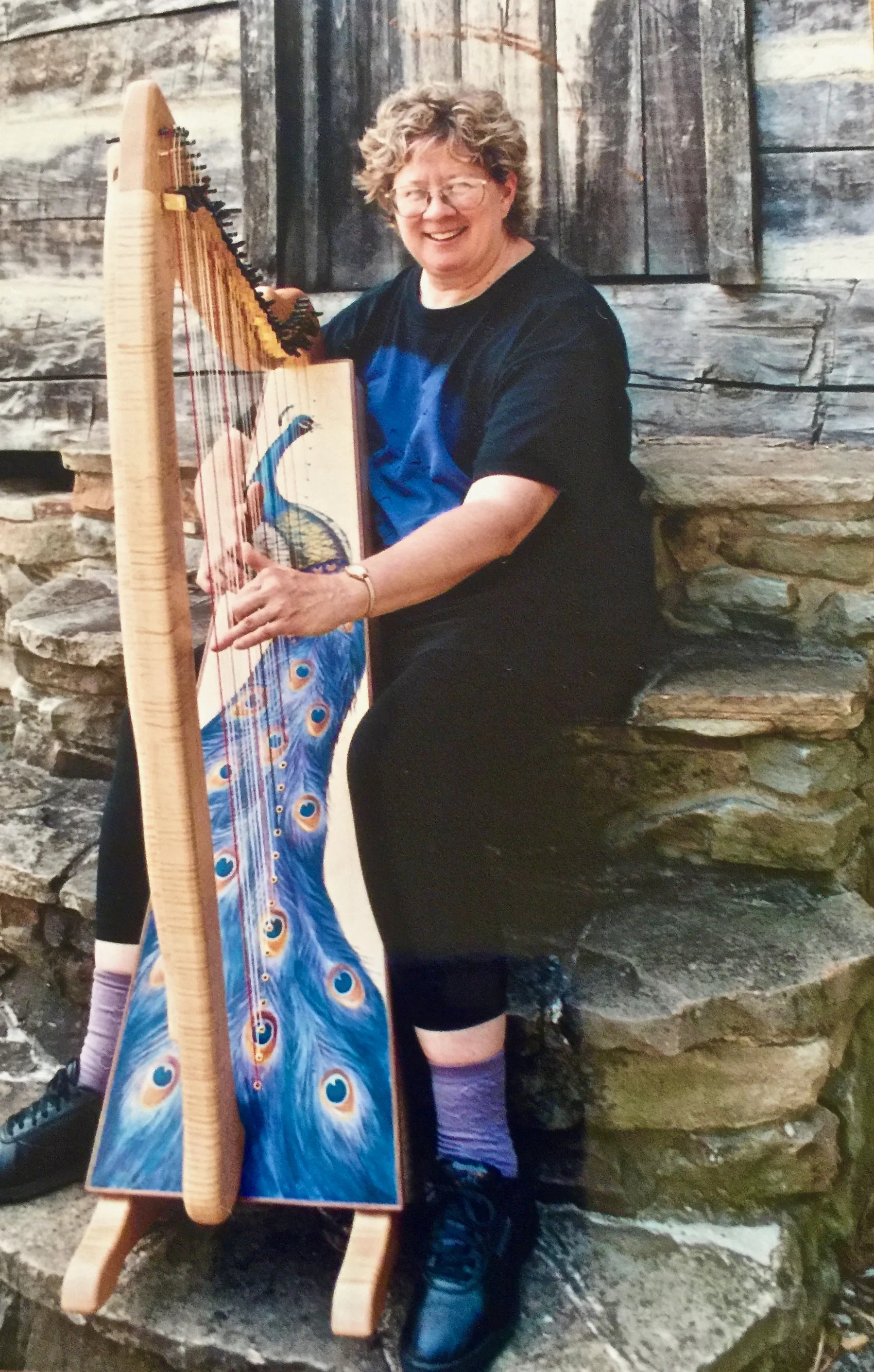Carol Thompson with her one-of-a-kind peacock Glen Aulin Harp.