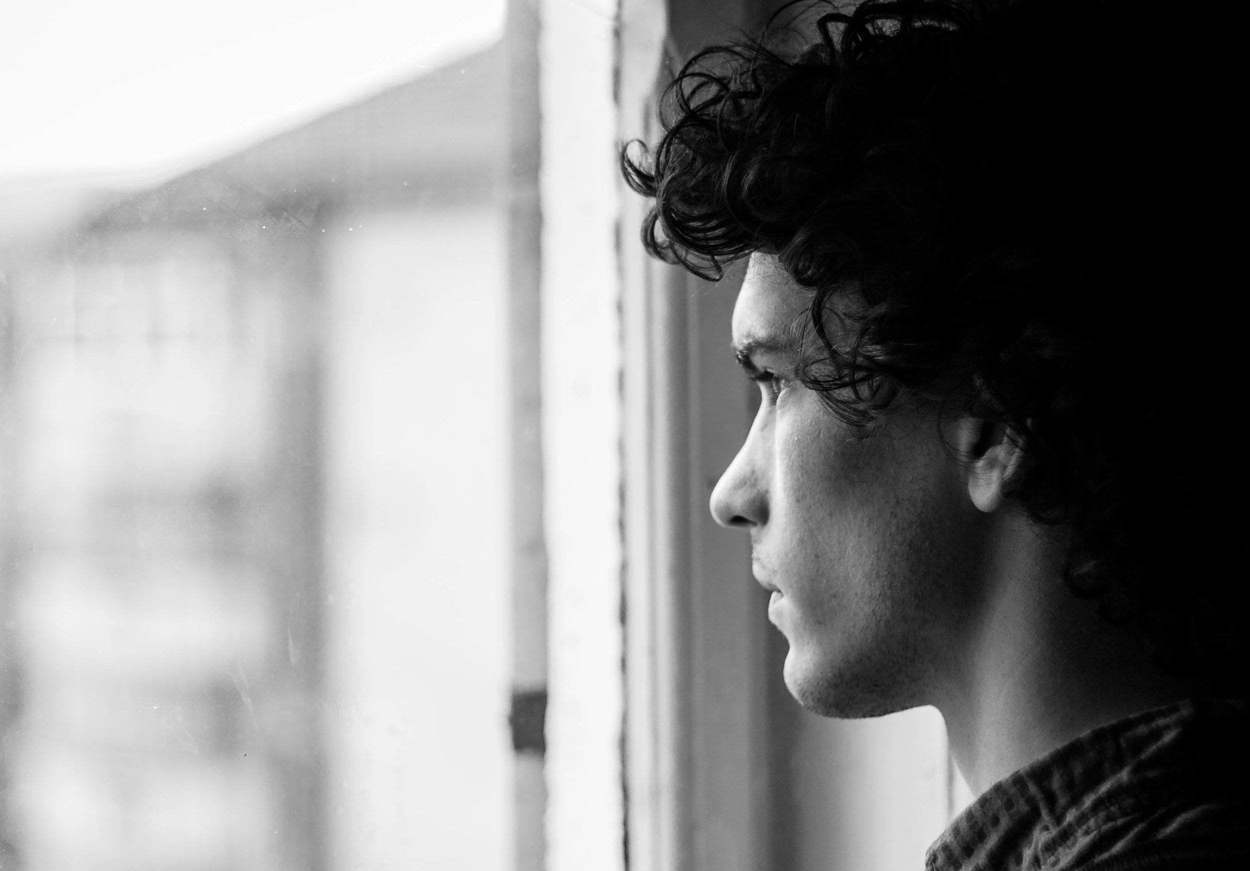 man looking out window.jpeg