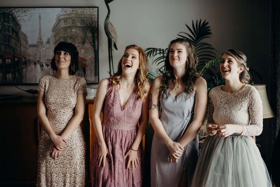 Kathryn's bridesmaids reacting to seeing her in her dress for the first time as she gracefully descended the stairs. We set it up in the dining room and moved some furniture around so that we could have lots of space with natural lighting.