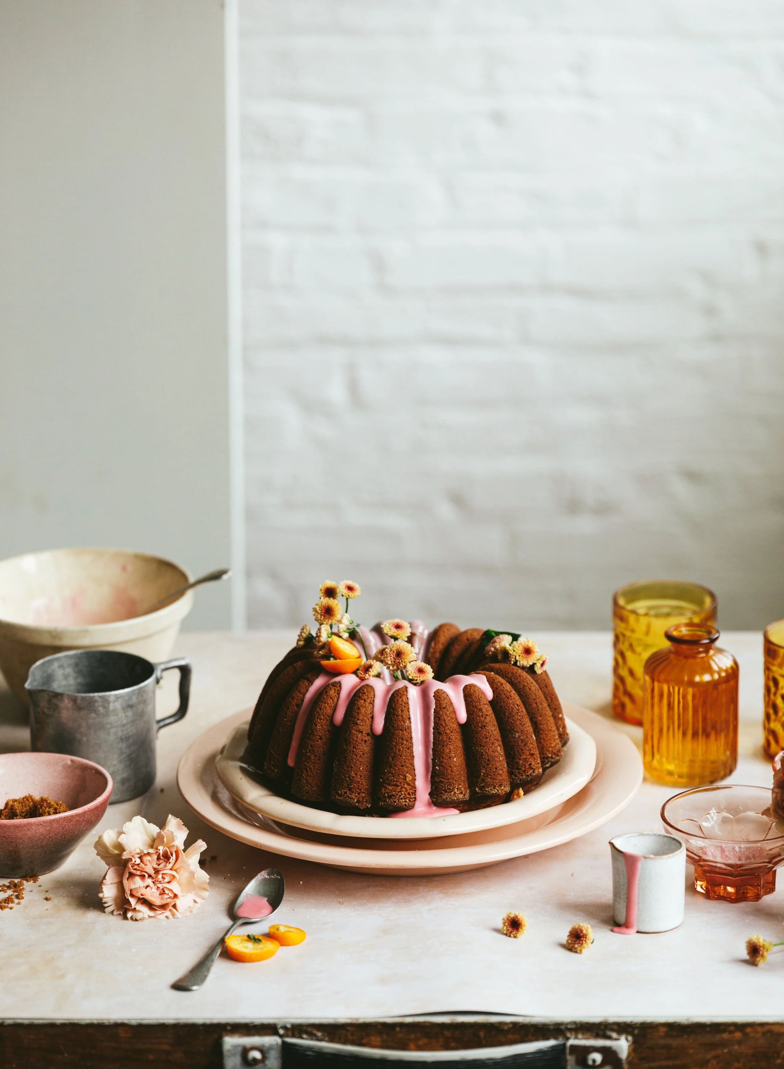 Blog post image showing a beautifully decorated bundt cake with pink icing and flowers
