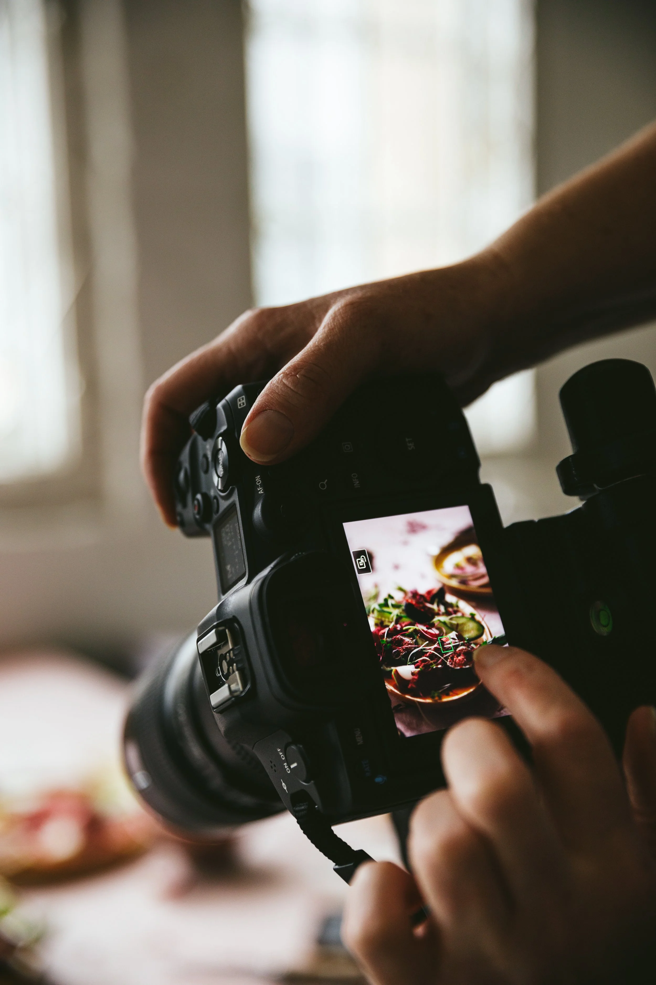 Blog post image showing a food scene visible through a camera preview screen