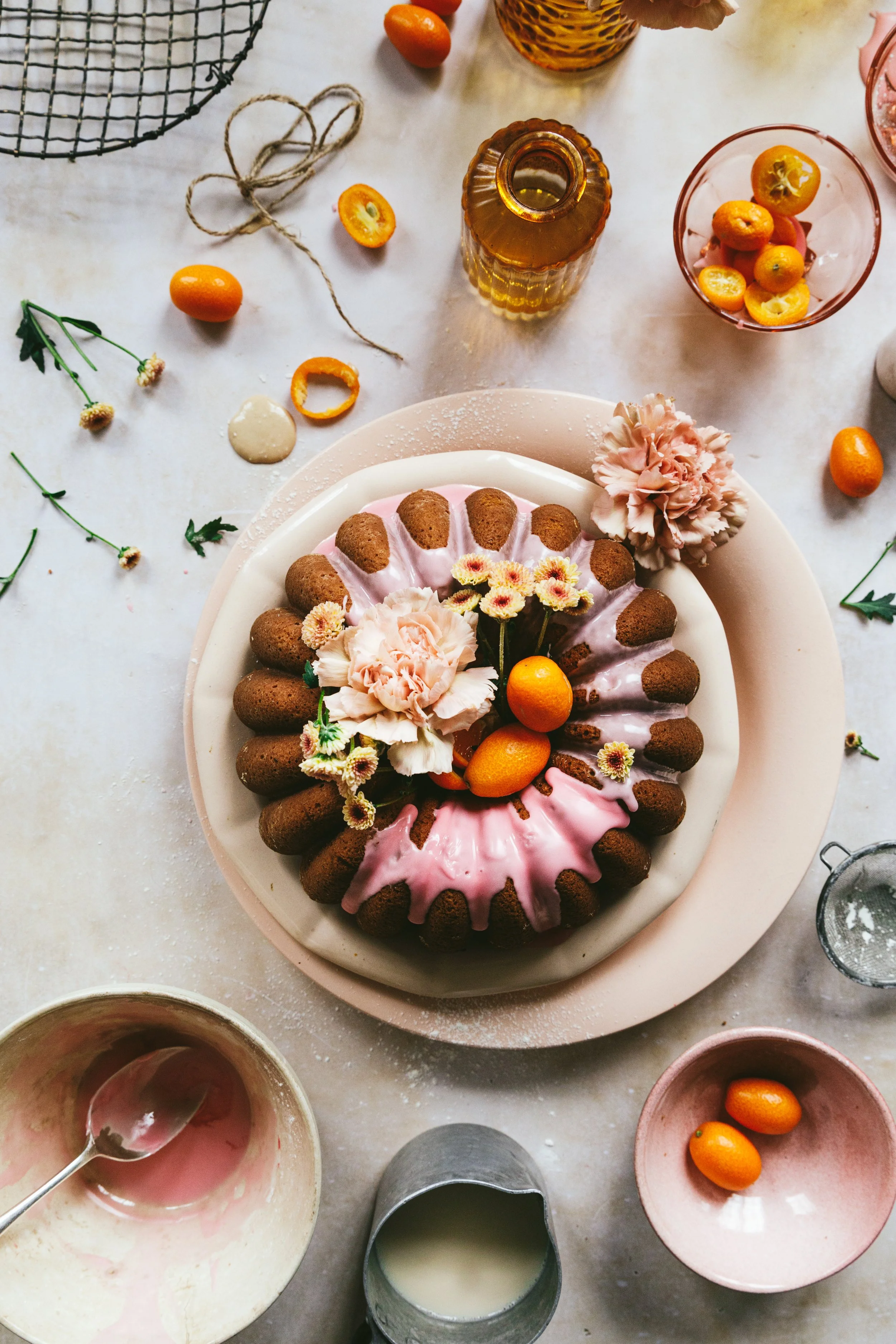 Blog post image with an overhead view of a bundt cake decorated with fruit and flowers