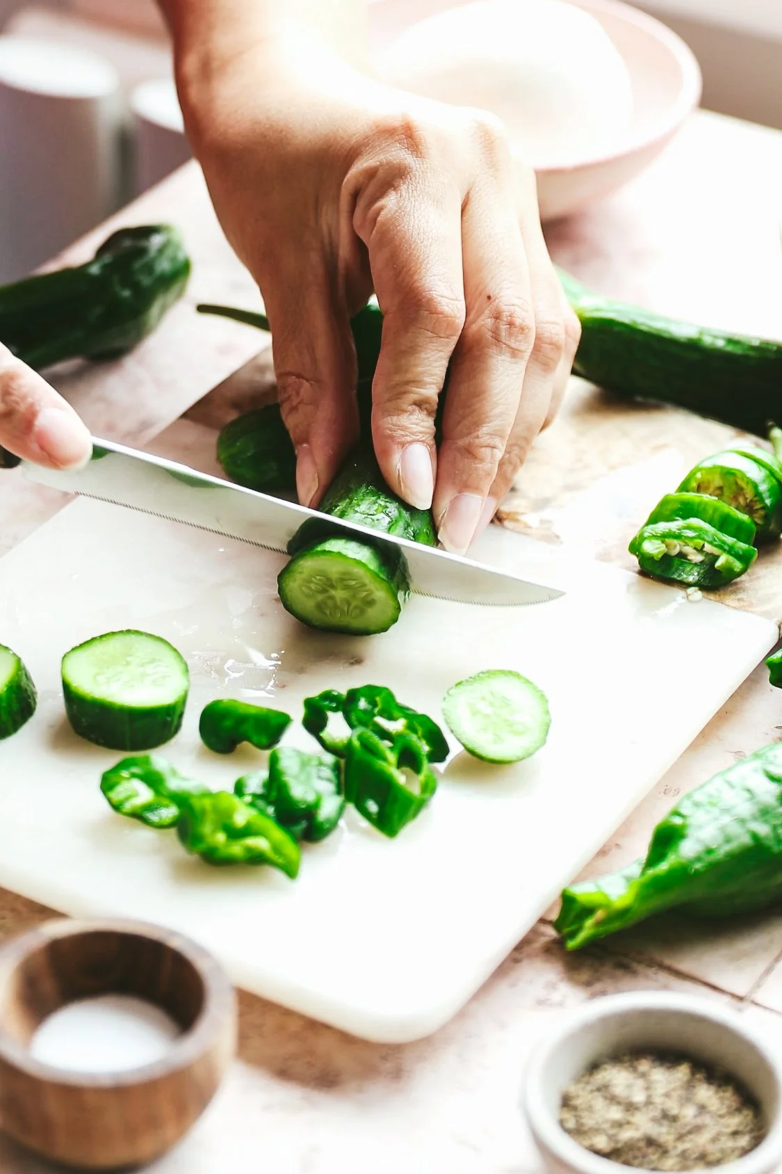 Blog post image showing hands slicing a mini cucumber